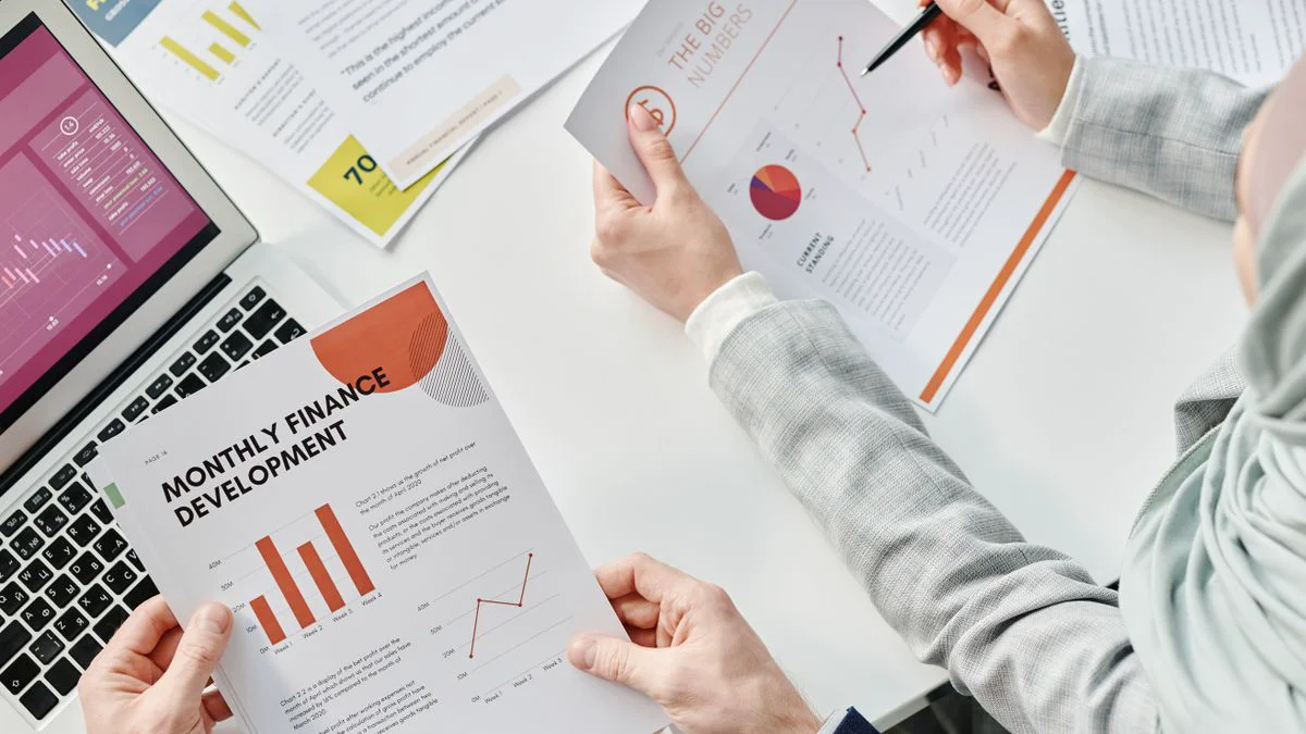 Colleagues reviewing printed charts during a business meeting