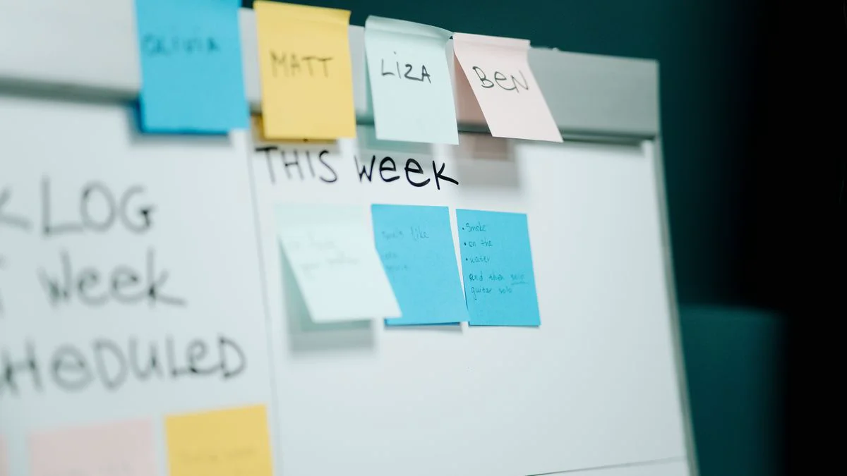 Team reviewing a content workflow board with research, draft, and publishing stages