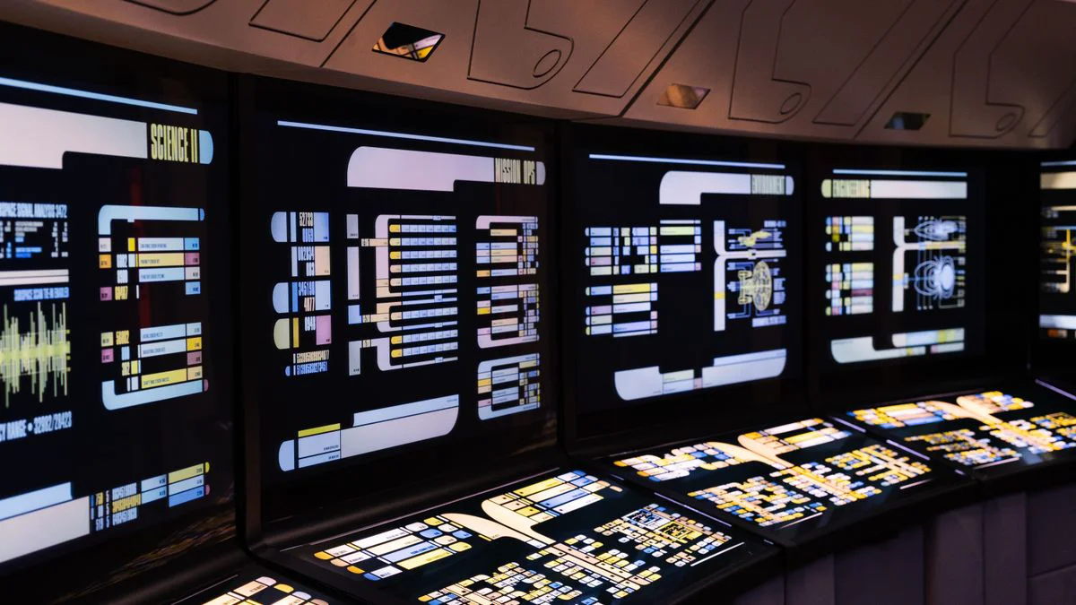 A marketer working at a desk with an automation dashboard on screen
