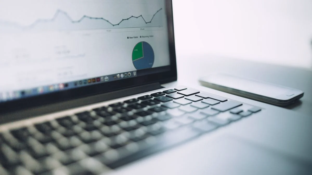 Marketer reviewing visibility charts on a laptop dashboard