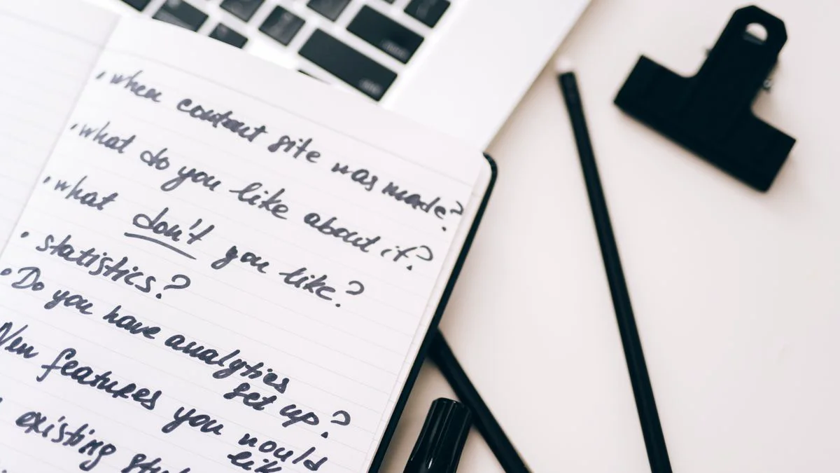 Notebook and laptop showing a content planning workflow