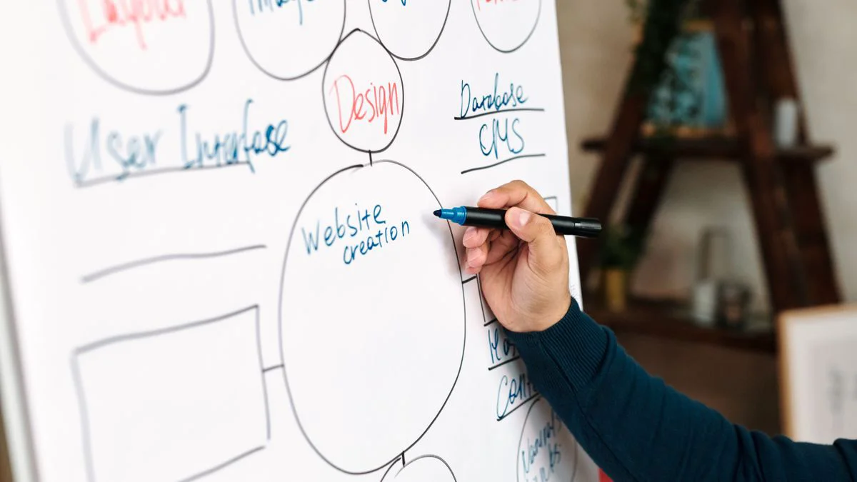 Person reviewing a website content management screen on a desktop monitor