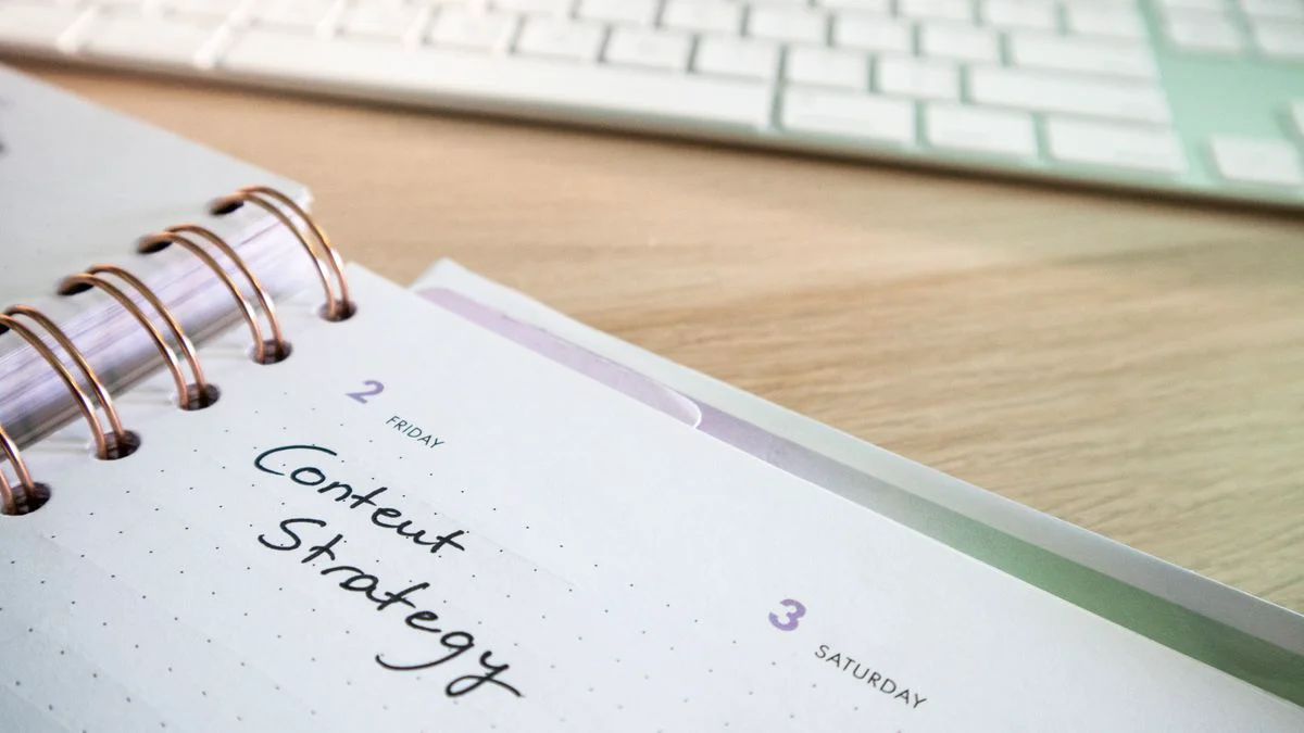 Marketing team reviewing a content calendar and workload notes on a desk