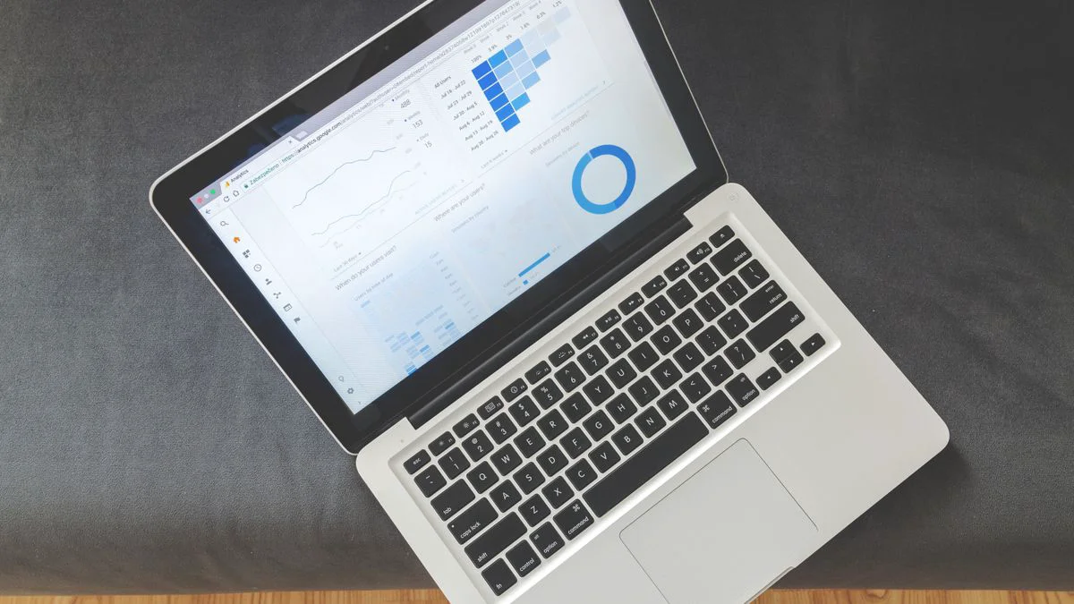 A laptop showing analytics dashboards and content planning screens