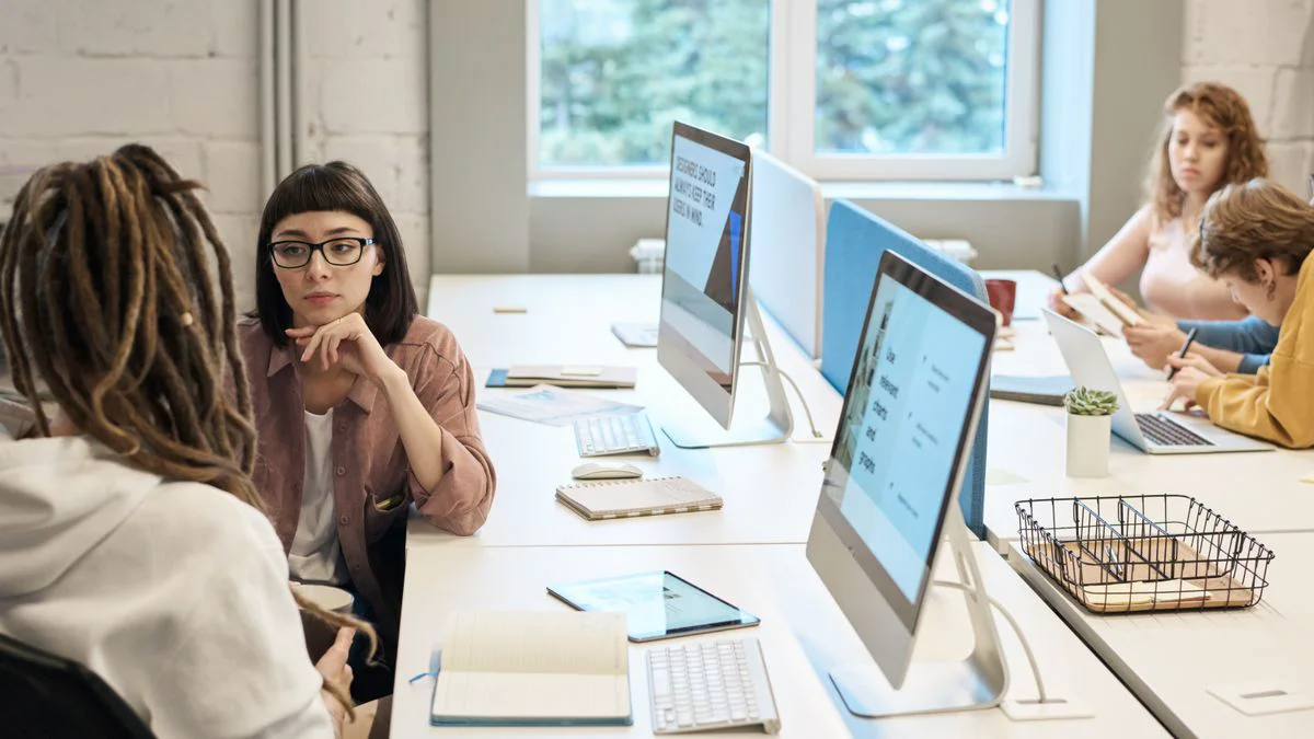 Team members reviewing website content at a shared desk