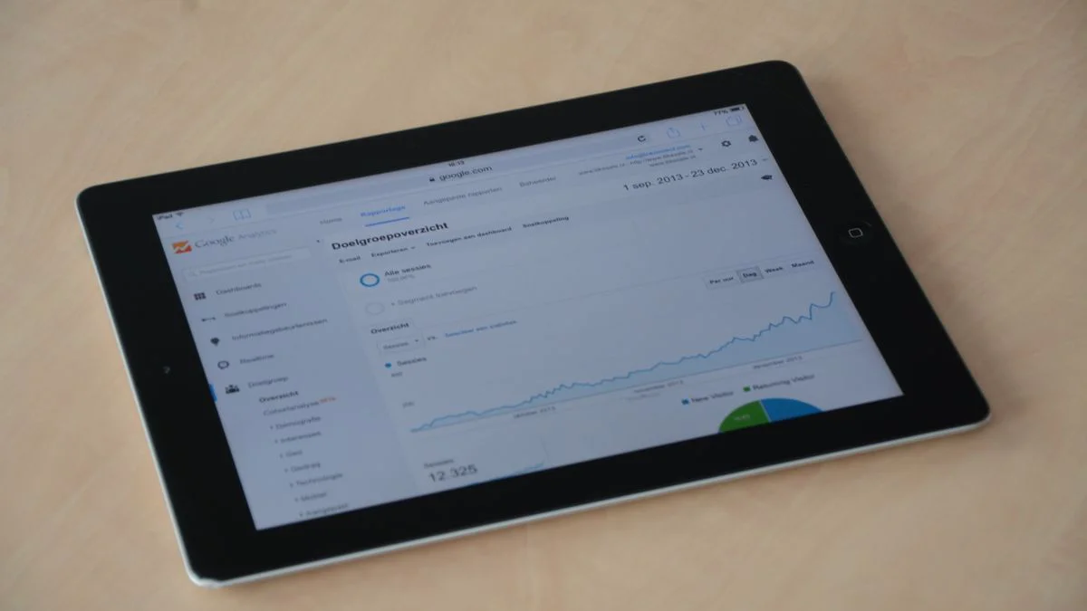 A laptop screen showing search performance charts and keyword trends on a desk
